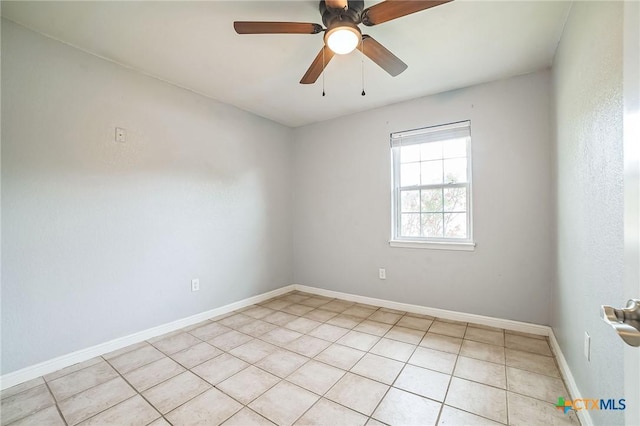801 E Johnson St, Burnet, TX 78611 - empty room featuring light tile patterned floors, a ceiling fan, and baseboards