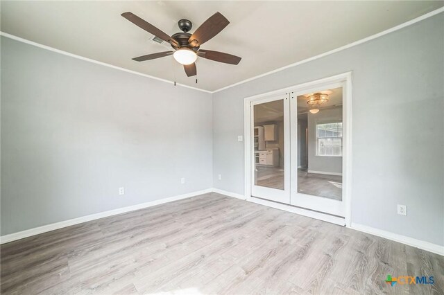 801 E Johnson St, Burnet, TX 78611 - unfurnished room featuring wood finished floors, baseboards, ceiling fan, ornamental molding, and french doors