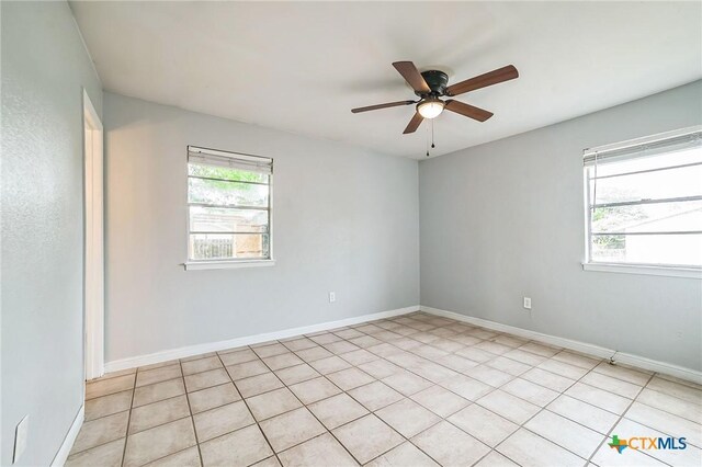 801 E Johnson St, Burnet, TX 78611 - spare room with ceiling fan, baseboards, and light tile patterned flooring