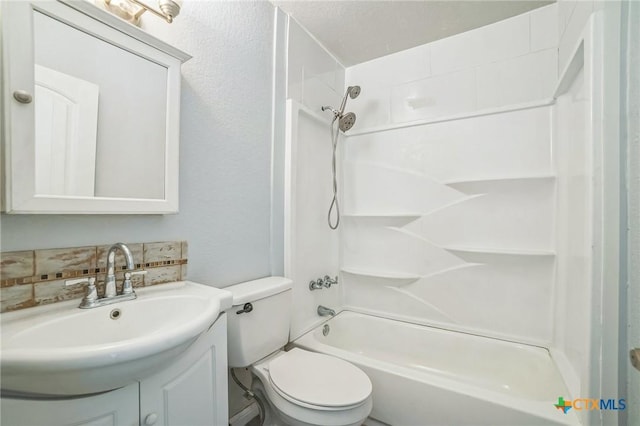 801 E Johnson St, Burnet, TX 78611 - full bathroom with vanity, toilet, washtub / shower combination, and backsplash