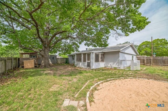 801 E Johnson St, Burnet, TX 78611 - view of yard with a sunroom, an outbuilding, and a shed