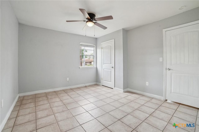 801 E Johnson St, Burnet, TX 78611 - unfurnished bedroom featuring a closet, baseboards, a ceiling fan, and light tile patterned flooring