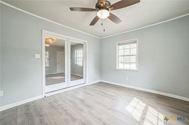 801 E Johnson St, Burnet, TX 78611 - spare room featuring healthy amount of natural light, ornamental molding, wood finished floors, and baseboards