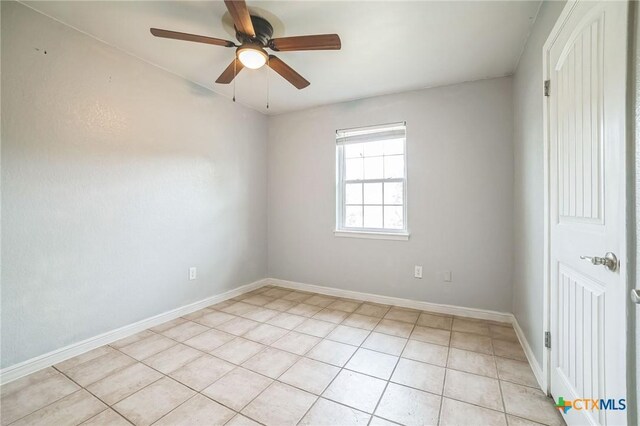 801 E Johnson St, Burnet, TX 78611 - unfurnished room featuring light tile patterned floors, ceiling fan, and baseboards