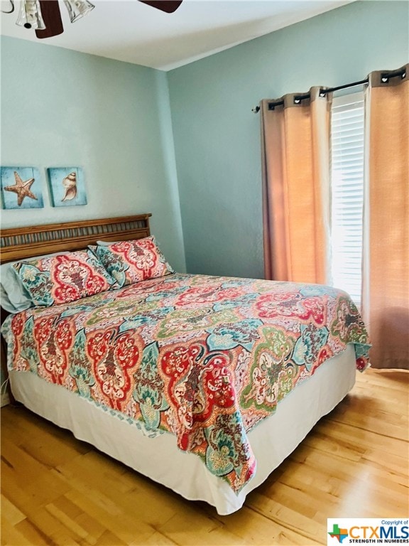 bedroom featuring hardwood / wood-style floors and ceiling fan