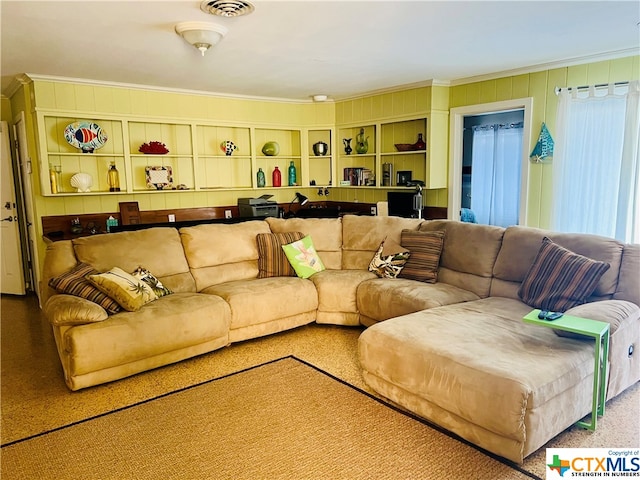 living room featuring carpet and crown molding