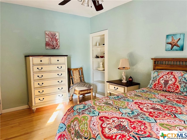 bedroom with light hardwood / wood-style floors and ceiling fan