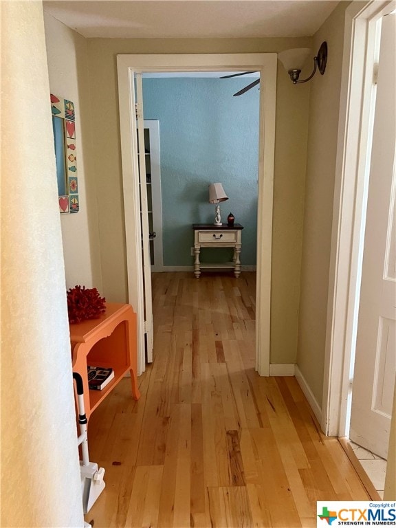 corridor with light hardwood / wood-style flooring