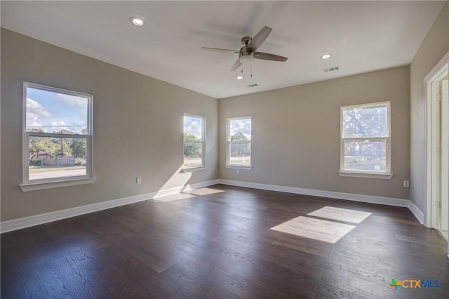 spare room with ceiling fan and dark wood-type flooring