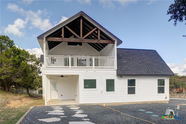 rear view of house featuring a balcony and a patio area