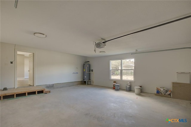 garage featuring electric water heater and a garage door opener