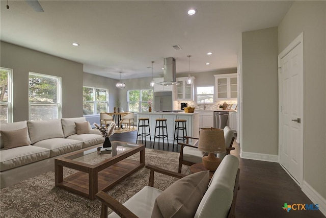 living room featuring dark hardwood / wood-style floors and a notable chandelier