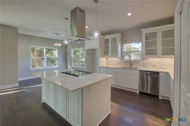 kitchen featuring white cabinets, island range hood, stainless steel dishwasher, and plenty of natural light