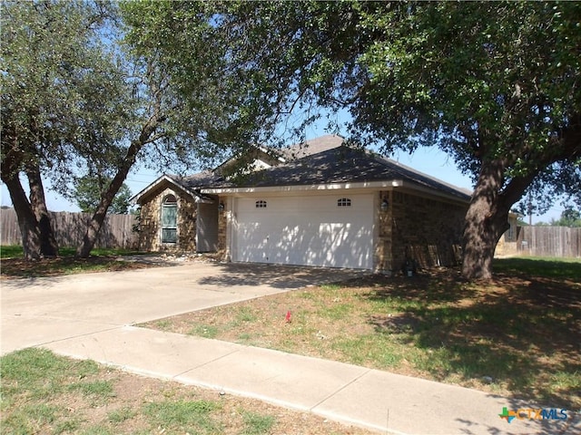 5705 Bald Ridge Ct, Killeen, TX 76542 - view of front of house featuring an attached garage, concrete driveway, and stone siding
