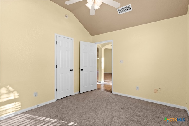 unfurnished bedroom featuring carpet, vaulted ceiling, and ceiling fan