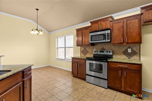 kitchen with light stone counters, stainless steel appliances, vaulted ceiling, light tile patterned floors, and an inviting chandelier