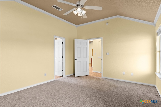 unfurnished bedroom with ceiling fan, light carpet, lofted ceiling, and ornamental molding