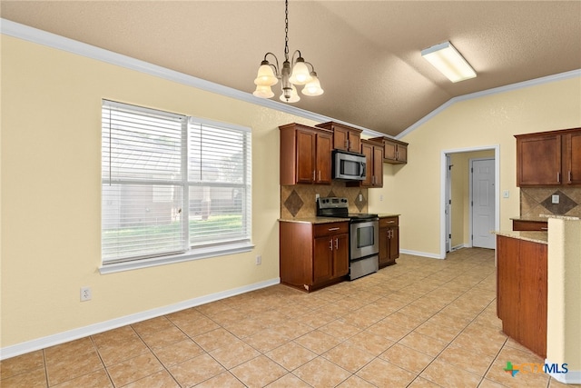 kitchen with a notable chandelier, crown molding, pendant lighting, lofted ceiling, and appliances with stainless steel finishes