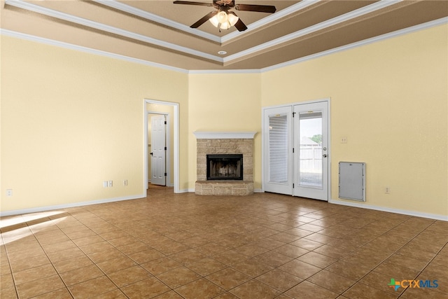 unfurnished living room with tile patterned flooring, ceiling fan, a fireplace, and crown molding