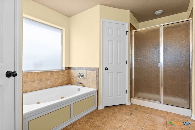 bathroom with tile patterned floors and separate shower and tub