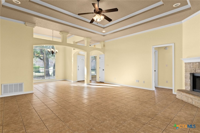 5705 Bald Ridge Ct, Killeen, TX 76542 - unfurnished living room with a tray ceiling, ornamental molding, a fireplace, arched walkways, and a chandelier