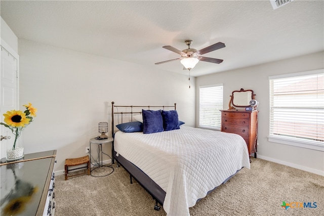 carpeted bedroom with a textured ceiling and ceiling fan