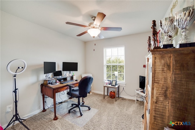 carpeted home office with ceiling fan