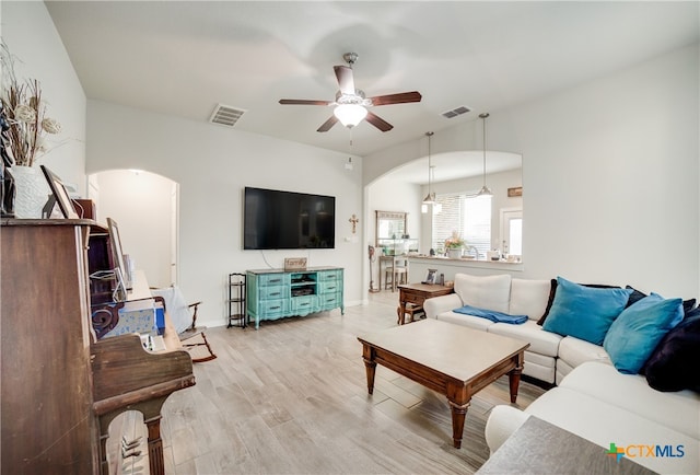 living room featuring light hardwood / wood-style flooring and ceiling fan