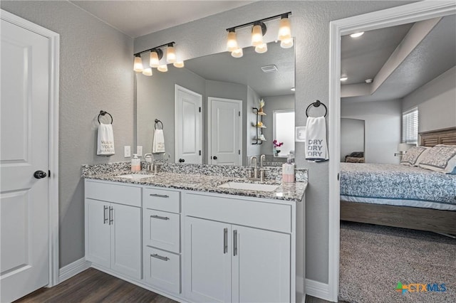 2446 Moreno Spur, Temple, TX 76501 - full bathroom featuring baseboards, ensuite bath, double vanity, and a sink