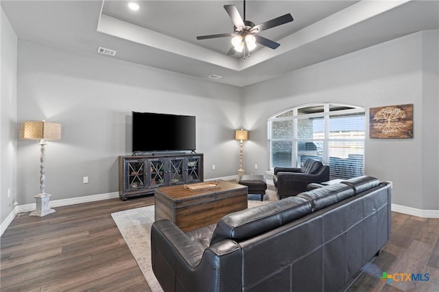 2446 Moreno Spur, Temple, TX 76501 - living room featuring ceiling fan, dark wood-type flooring, a tray ceiling, visible vents, and baseboards