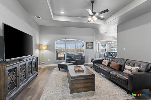 2446 Moreno Spur, Temple, TX 76501 - living room featuring baseboards, visible vents, ceiling fan with notable chandelier, wood finished floors, and a raised ceiling