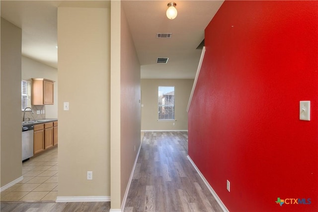 2109 Vernice Dr, Copperas Cove, TX 76522 - corridor with light wood-type flooring, visible vents, baseboards, and a sink