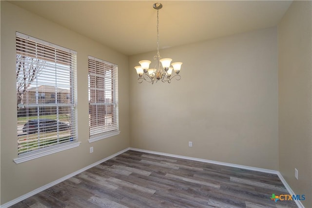 2109 Vernice Dr, Copperas Cove, TX 76522 - spare room with an inviting chandelier, dark wood-type flooring, and baseboards