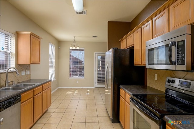 2109 Vernice Dr, Copperas Cove, TX 76522 - kitchen with a sink, dark countertops, stainless steel appliances, a notable chandelier, and visible vents