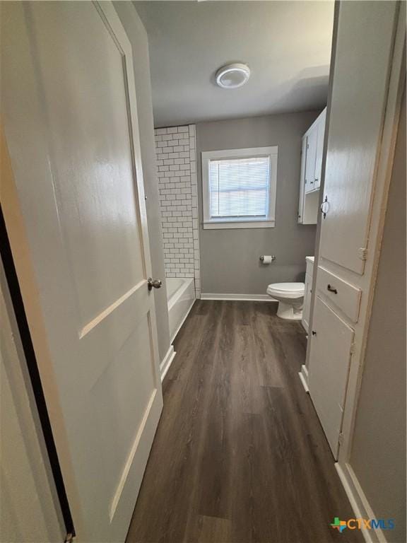 bathroom with hardwood / wood-style flooring and toilet