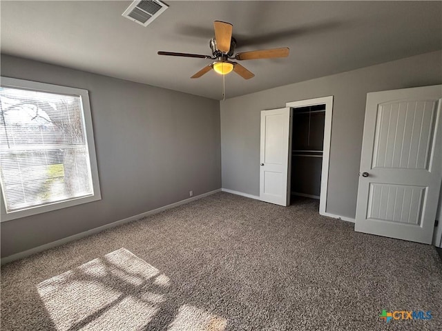 unfurnished bedroom featuring a closet, ceiling fan, and dark colored carpet