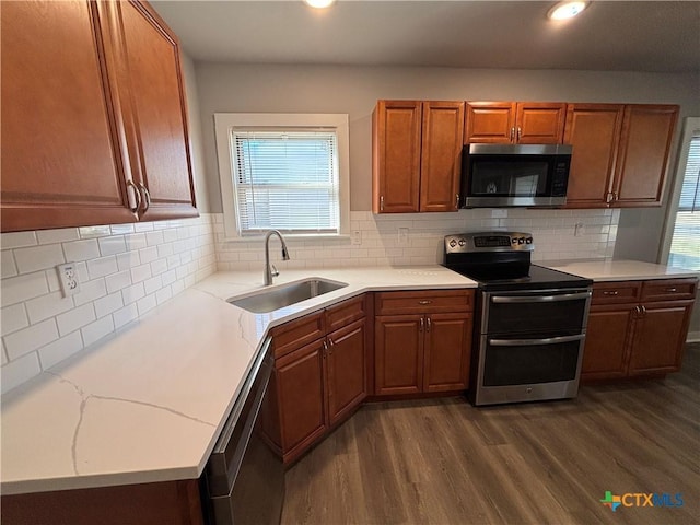 kitchen featuring stainless steel appliances, tasteful backsplash, sink, and dark hardwood / wood-style flooring