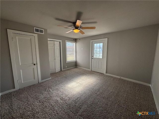 unfurnished bedroom featuring ceiling fan, a closet, and carpet