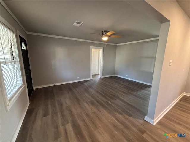 spare room with crown molding, ceiling fan, and dark hardwood / wood-style floors