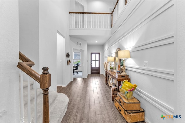 entrance foyer with a high ceiling and hardwood / wood-style floors