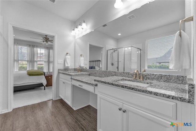 bathroom featuring ceiling fan, plenty of natural light, vanity, and wood-type flooring