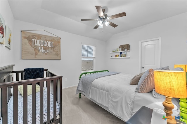 carpeted bedroom featuring ceiling fan and vaulted ceiling