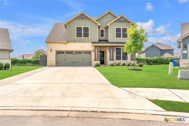 craftsman-style house featuring a garage and a front yard