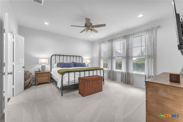 bedroom featuring light colored carpet and ceiling fan