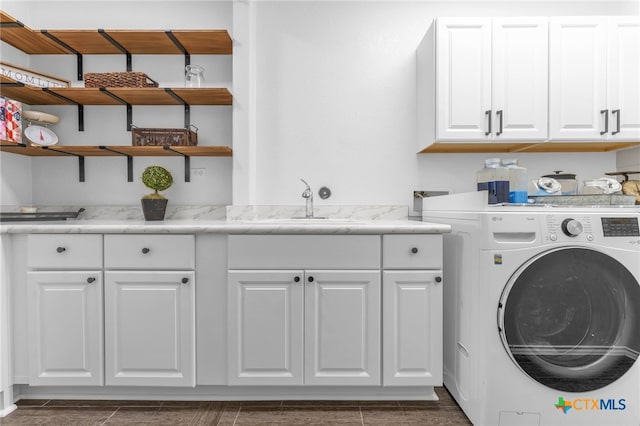 laundry room featuring washer / clothes dryer, sink, and cabinets