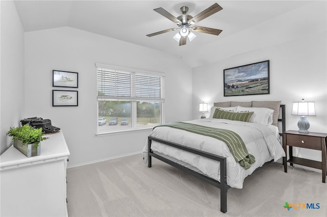 bedroom with light colored carpet, ceiling fan, and lofted ceiling