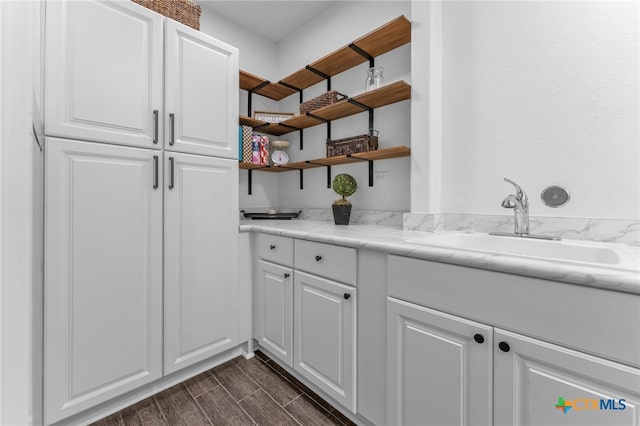 interior space with dark hardwood / wood-style flooring and sink