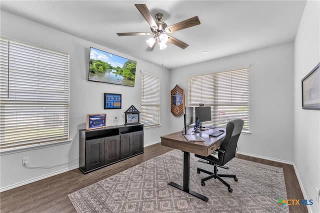 office with dark hardwood / wood-style floors and ceiling fan