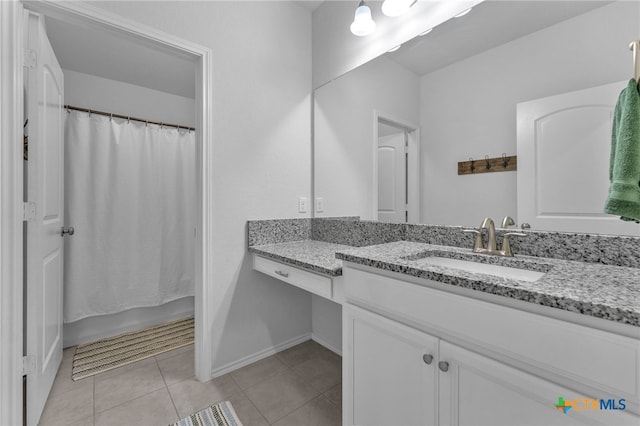 bathroom with tile patterned floors, shower / tub combo with curtain, and vanity