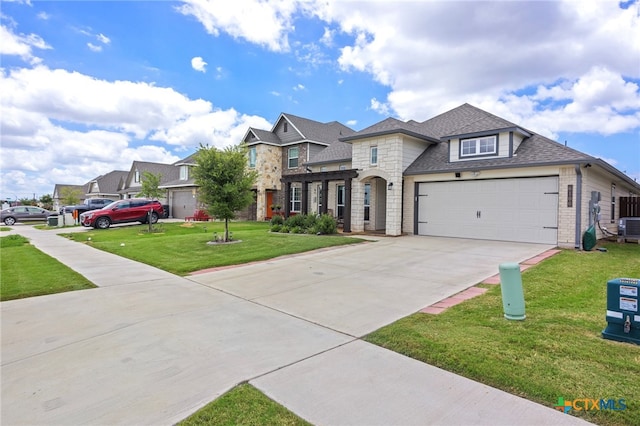 view of front of home with a front lawn, a garage, and central AC unit